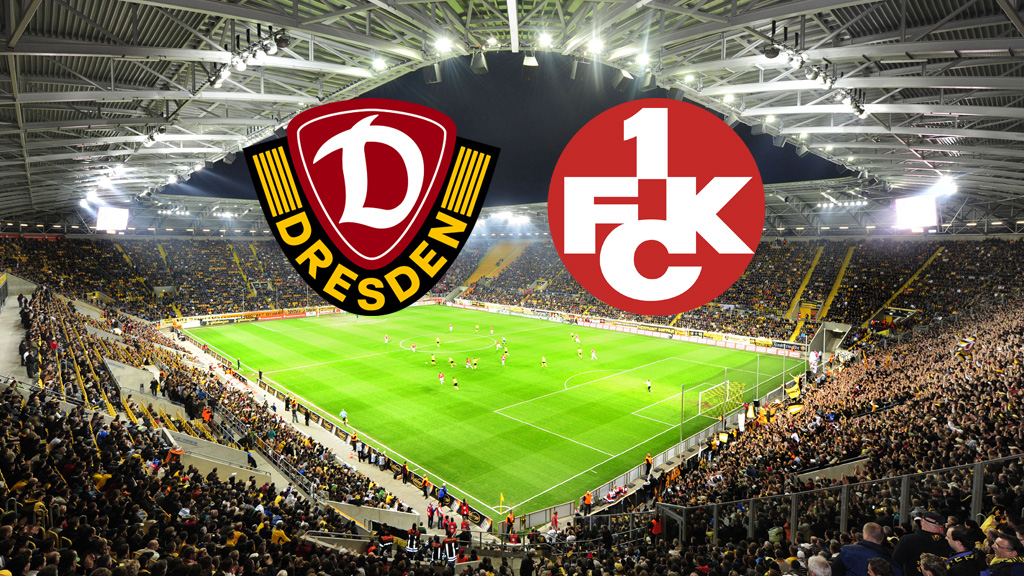 Ein breites, horizontales Bild zeigt ein Fußballstadion, das voll von Fans ist, die gelbe Trikots tragen. Auf dem Spielfeld sind Fußballspieler zu sehen. Am oberen Rand des Bildes, in der Mitte, befinden sich zwei Logos. Das linke Logo ist das Wappen von Dynamo Dresden, das rechte Logo ist das Wappen des 1. FC Kaiserslautern.