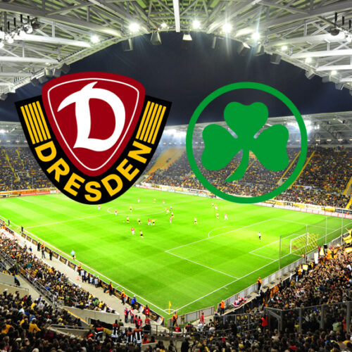 Ein Weitwinkelbild eines Fußballstadions, gefüllt mit jubelnden Fans. Über dem Spielfeld schweben die Logos zweier Fußballvereine: Dynamo Dresden (links, dunkelrot und gelb mit einem „D“) und SpVgg Greuther Fürth (rechts, grün mit einem Kleeblatt).