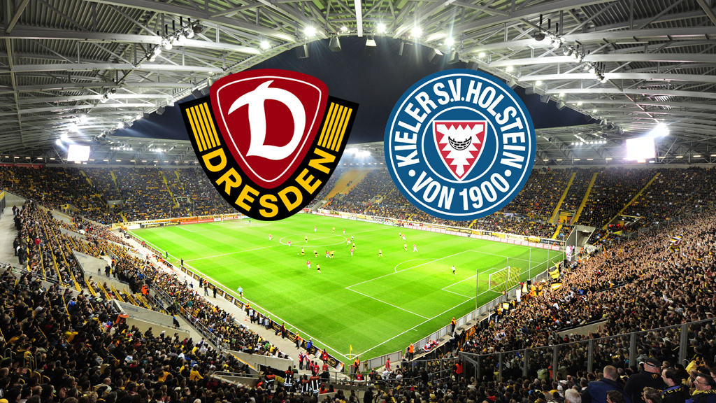 Ein breites, horizontales Bild zeigt ein Fußballstadion, das voll von Fans ist, die gelbe Trikots tragen. Auf dem Spielfeld sind Fußballspieler zu sehen. Am oberen Rand des Bildes, in der Mitte, befinden sich zwei Logos. Das linke Logo ist das Wappen von Dynamo Dresden, das rechte Logo ist das Wappen von Holstein Kiel.