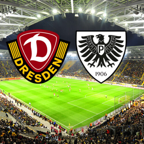 Ein breites, horizontales Bild zeigt ein Fußballstadion, das voll von Fans ist, die gelbe Trikots tragen. Auf dem Spielfeld sind Fußballspieler zu sehen. Am oberen Rand des Bildes, in der Mitte, befinden sich zwei Logos. Das linke Logo ist das Wappen von Dynamo Dresden, das rechte Logo ist das Wappen des SC Preußen Münster.